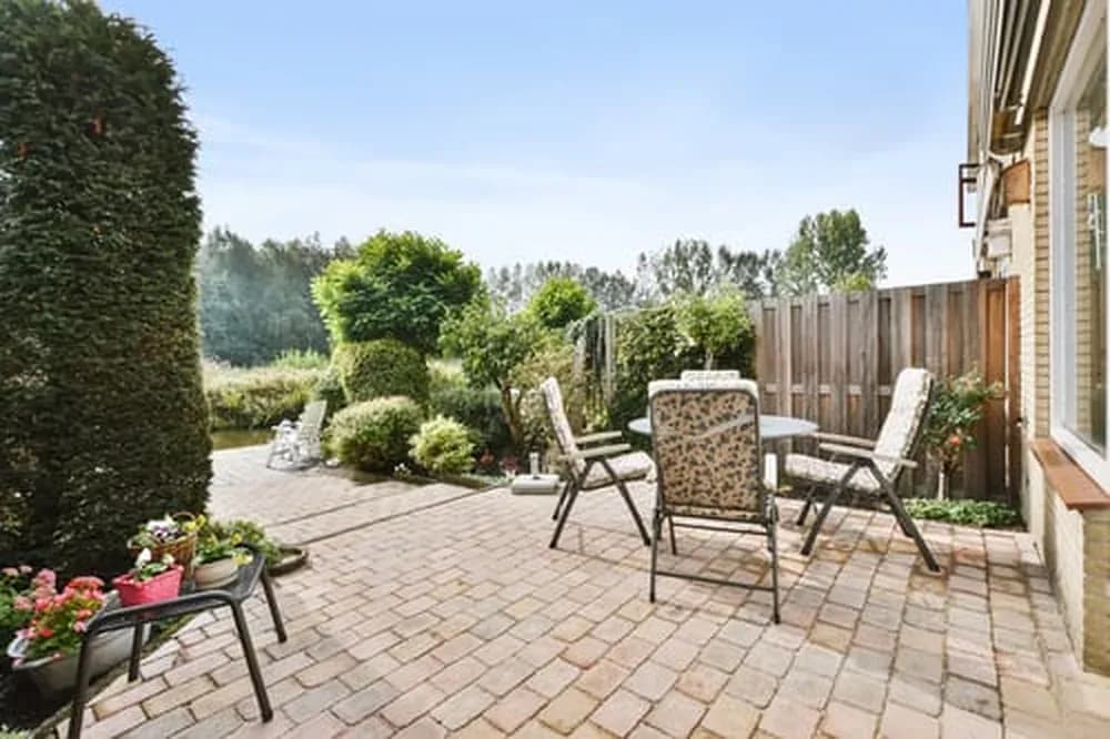 Backyard patio finished with interlocking pavers and outdoor seating